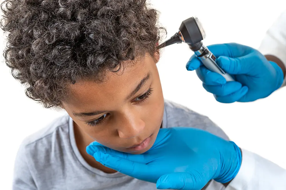 A boy having his ears examined