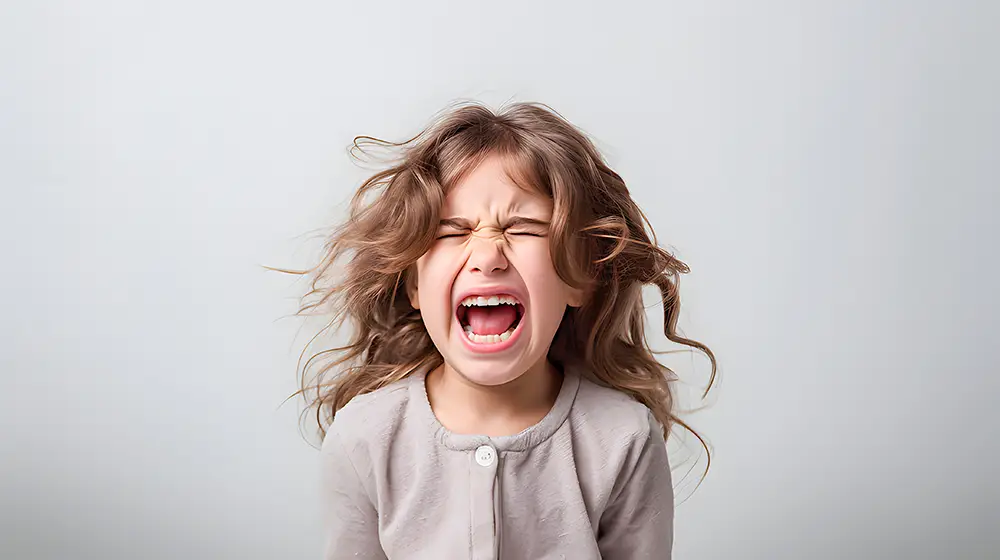 A girl screaming set against a light gray background