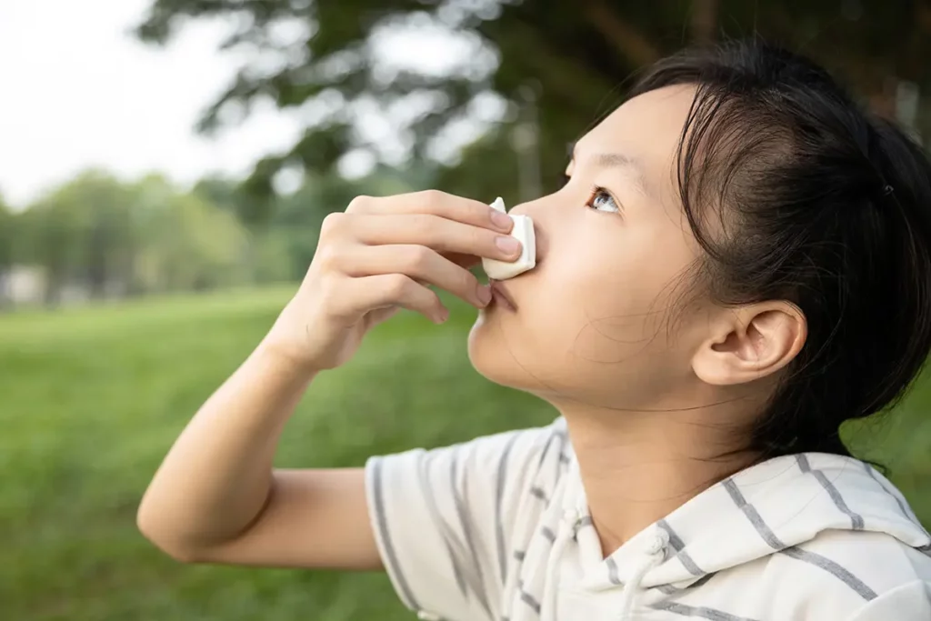 A young girl with a nosebleed